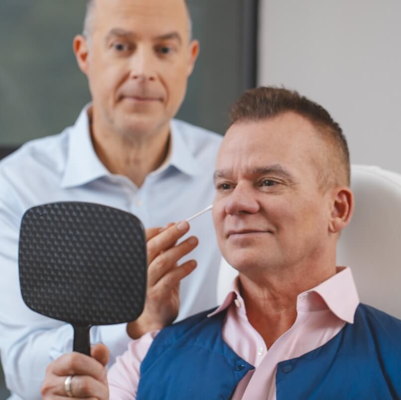Older gentleman looking in a mirror