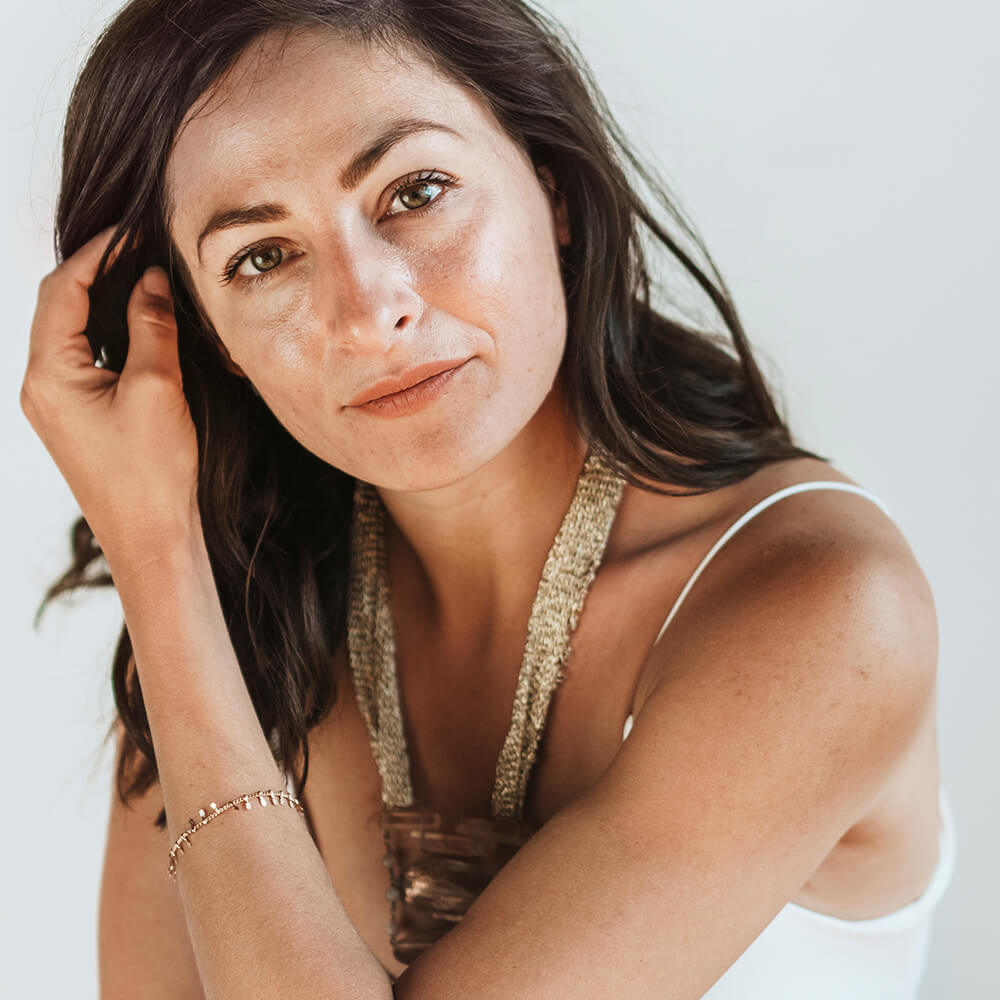 Pretty brunette woman with her hand in her hair