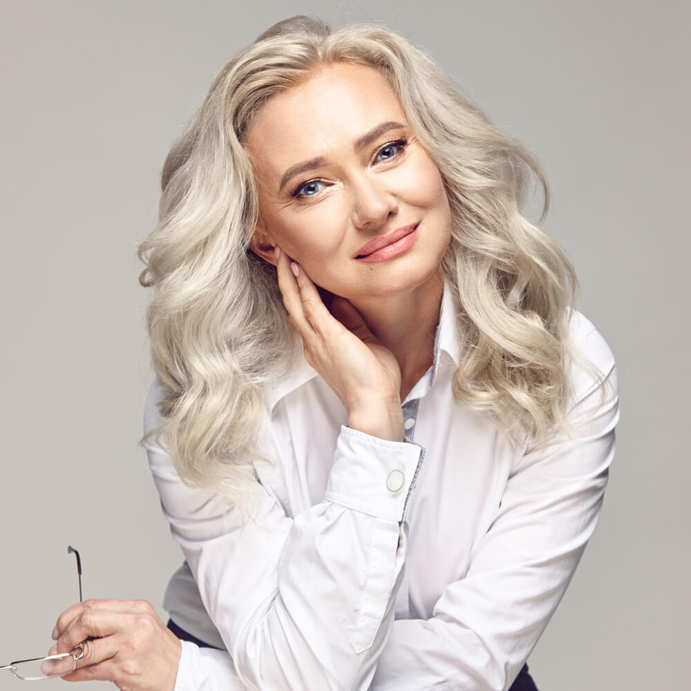 Mature blond in a white button up shirt